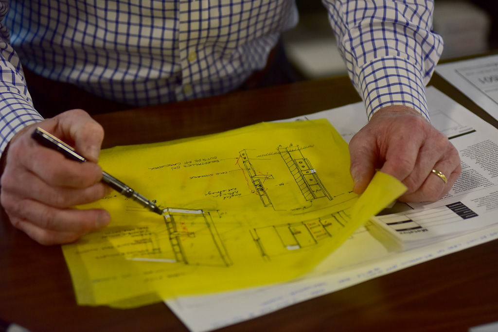 Commercial architect Robbie Price looks over designs for a salon renovation